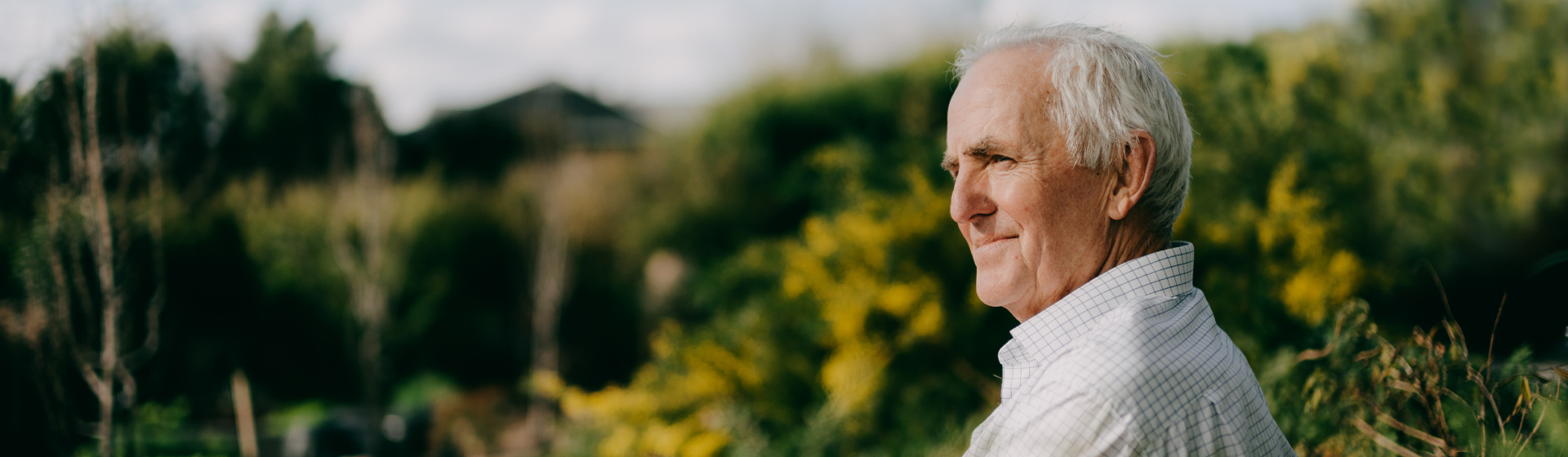Man looks off into distance and smiles