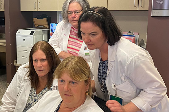 Group of nurses looking at a computer